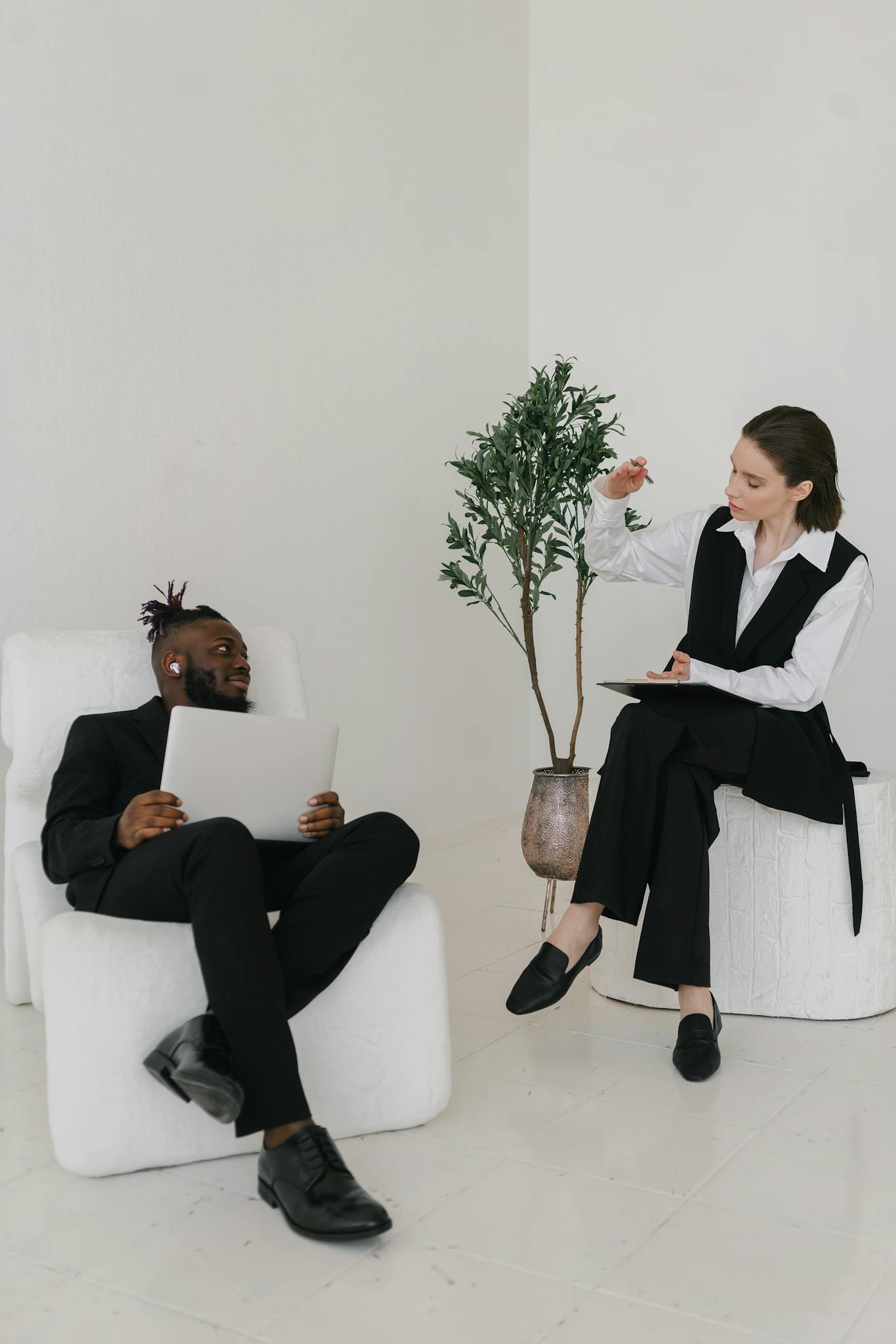 Diverse adults engaging in a productive business meeting with digital devices indoors.